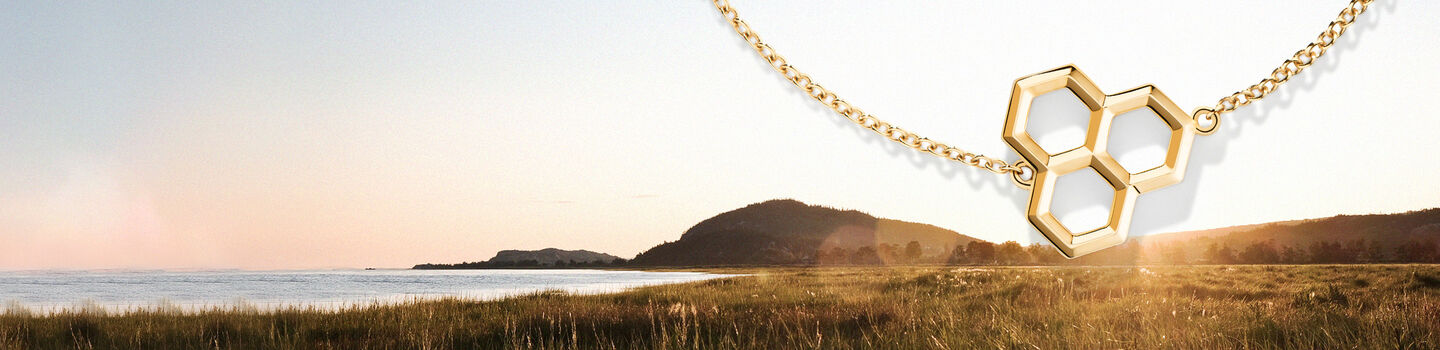 Birks Bee Chic gold honeycomb bracelet on a nature inspired background