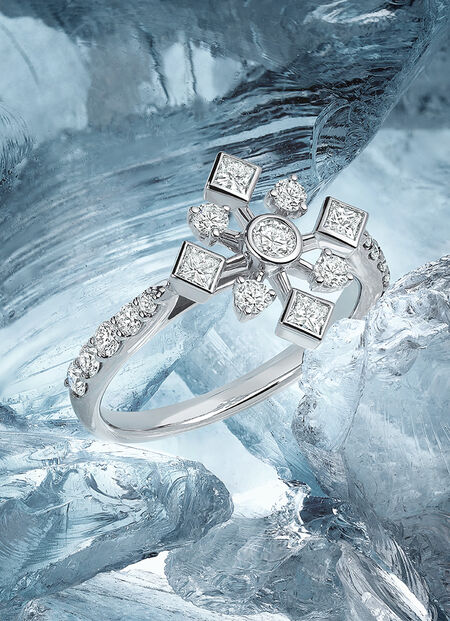Birks Snowflake diamond ring on a snowy background.
