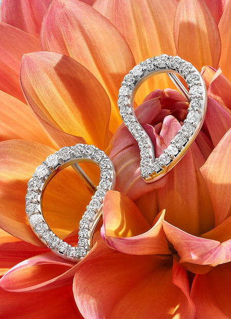 Birks Pétale diamond earrings on a flower.