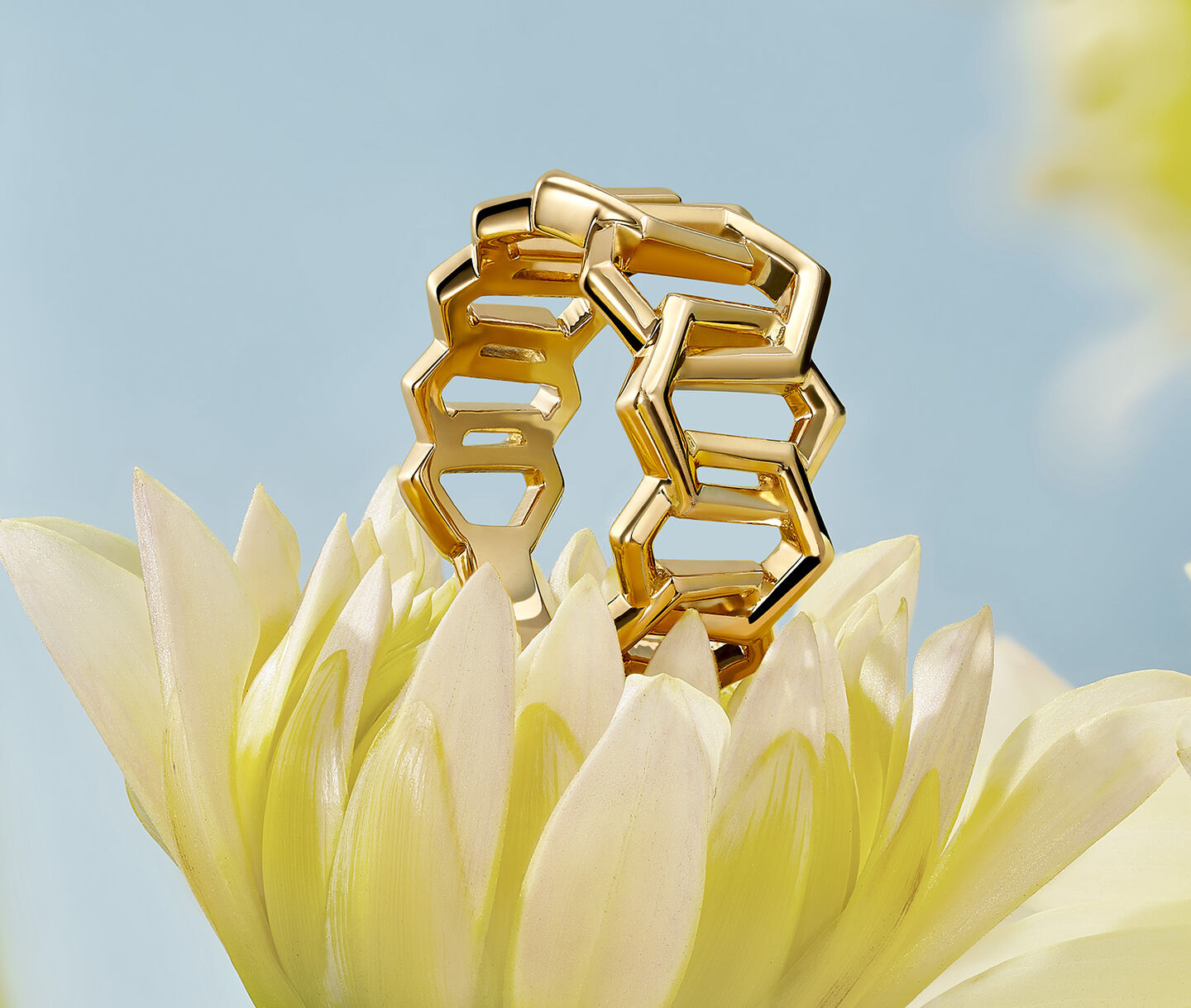 Birks Bee Chic gold ring resting on a flower.