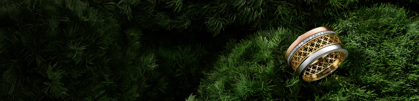 Birks Dare to Dream ring on a grassy background.